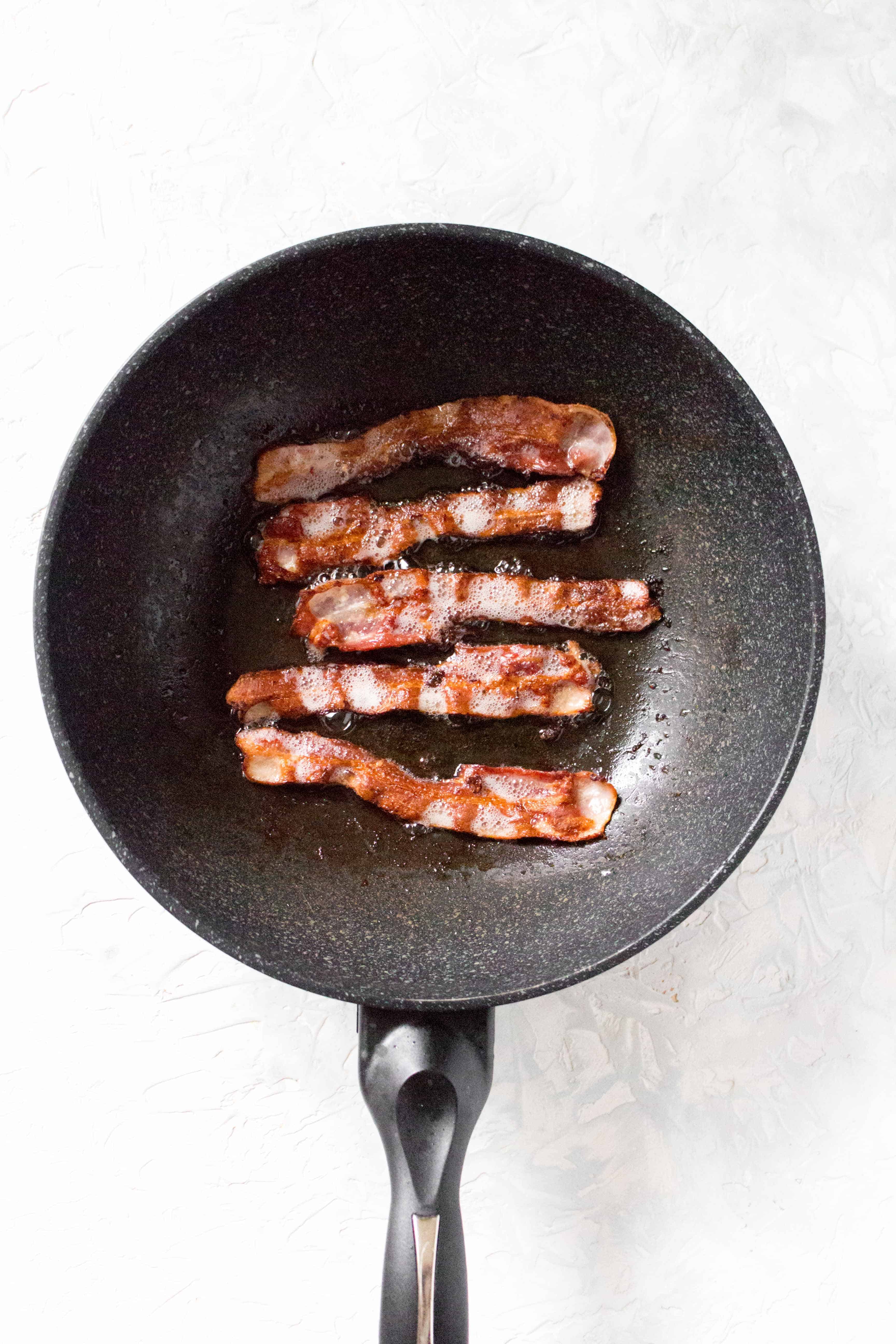 In a large skillet on medium heat, cook your bacon until it is at the level of crispiness you desire. When done, set the bacon aside, do not drain the bacon fat.