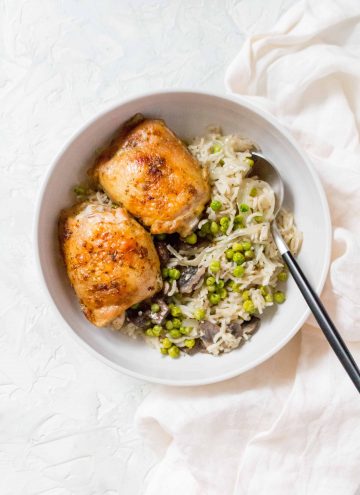 one pot chicken thighs with rice, mushrooms, peas, and onion