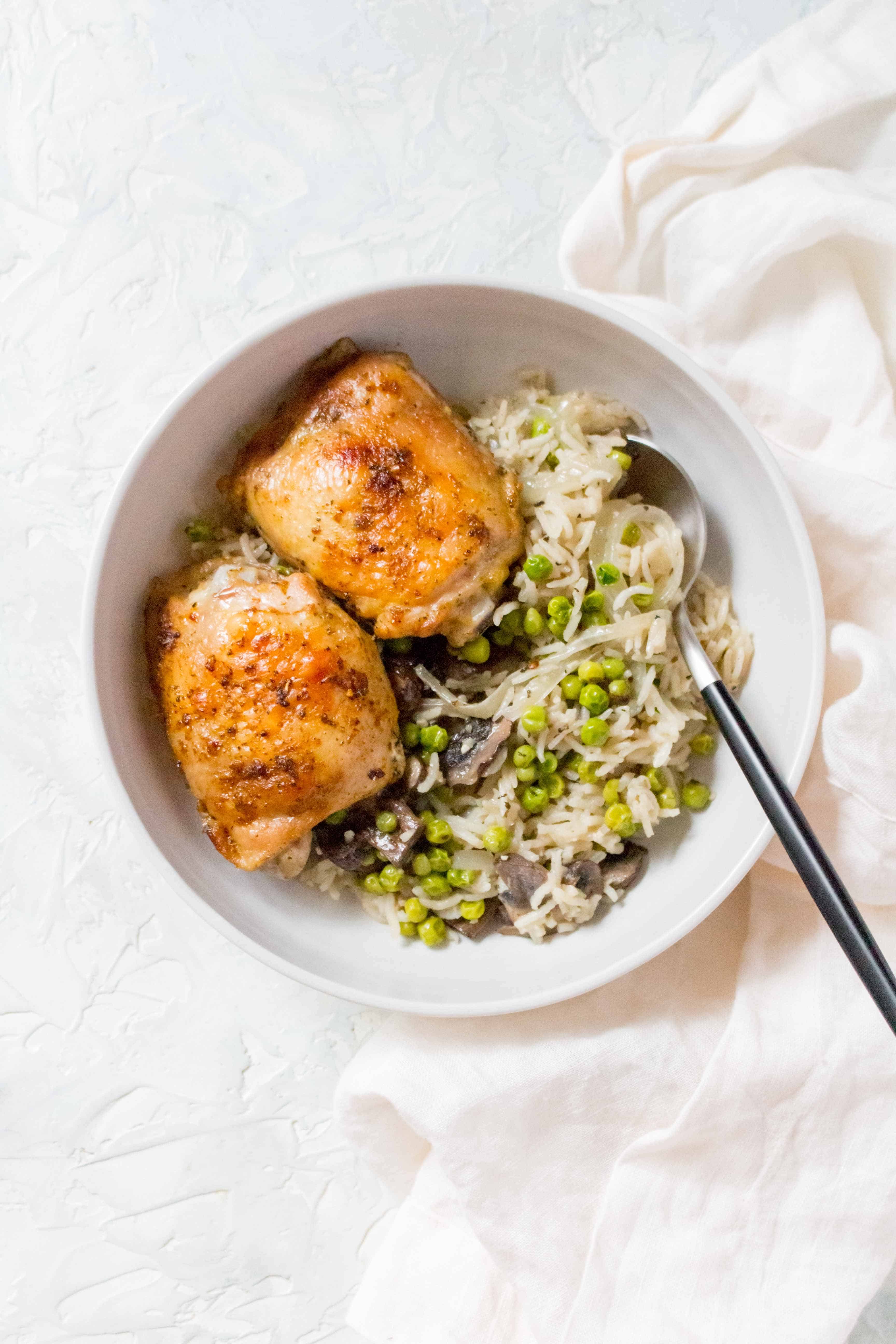 one pot chicken thighs with rice, mushrooms, peas, and onion