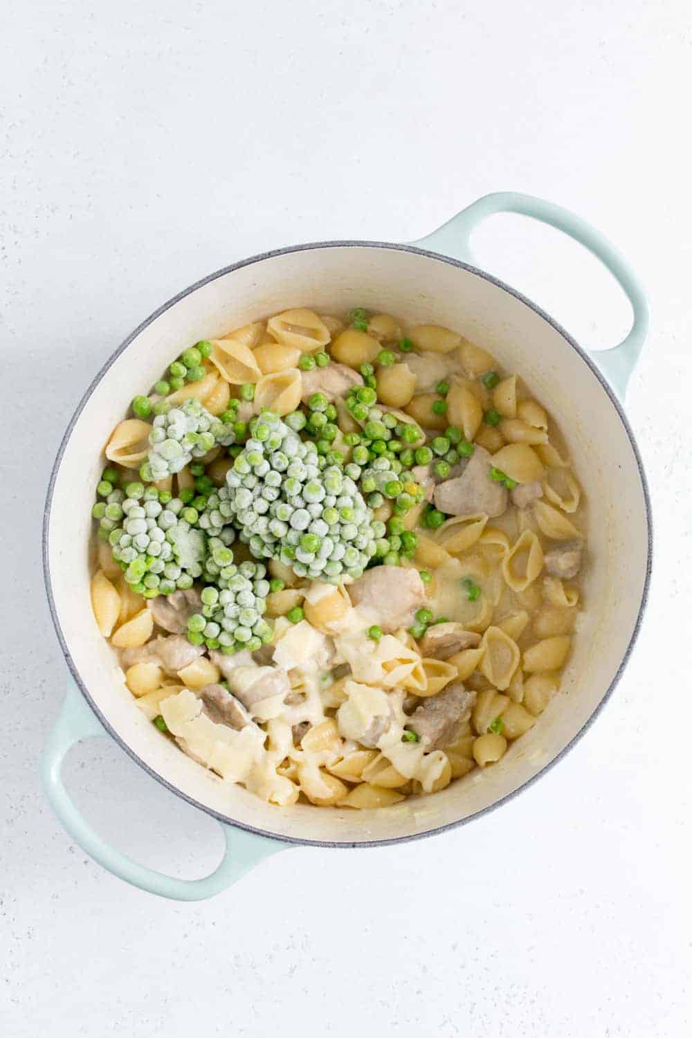 dutch oven with frozen peas and parmesan added inside