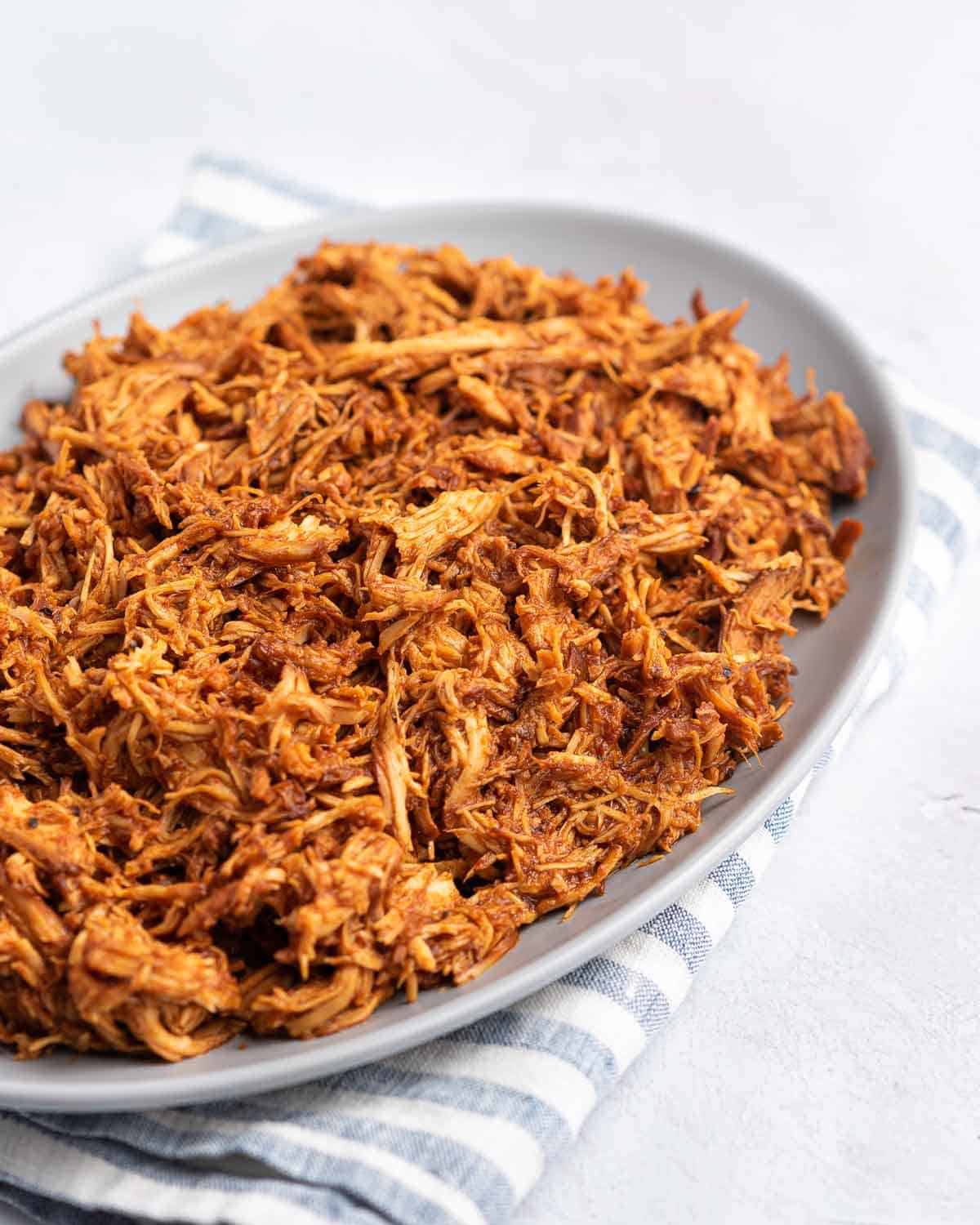 Close up of a platter of slow cooker bbq pulled chicken.