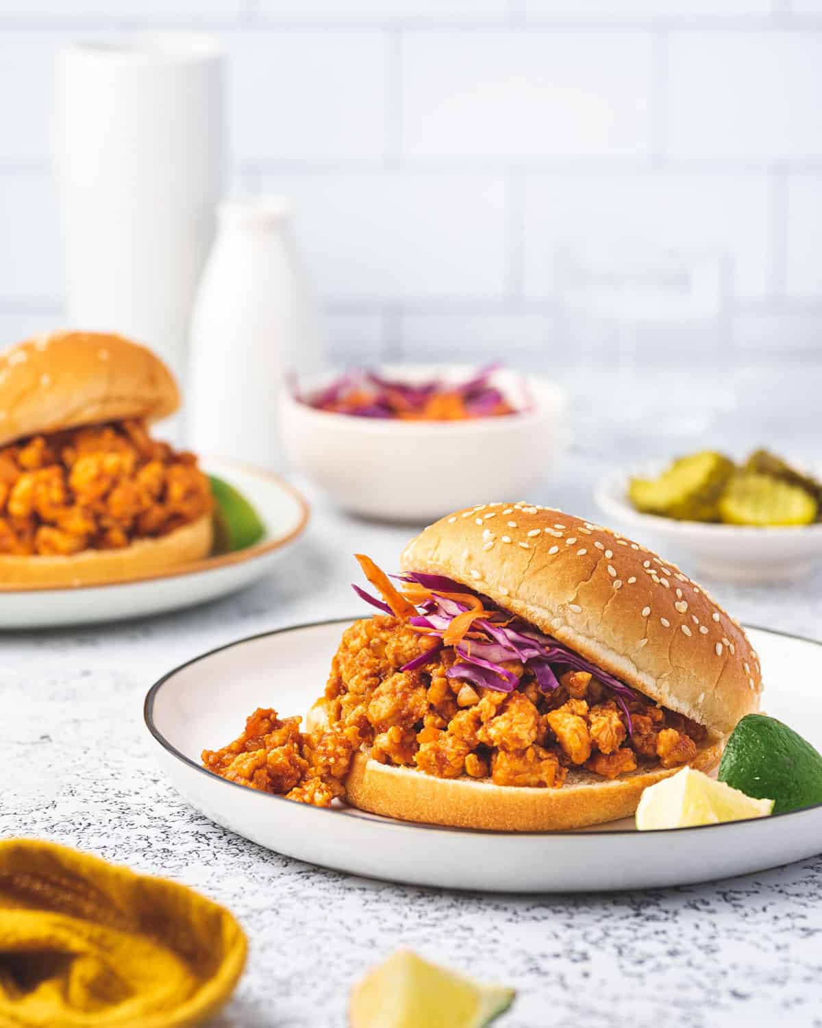 A plate of sloppy joes with ground chicken in a burger bun.