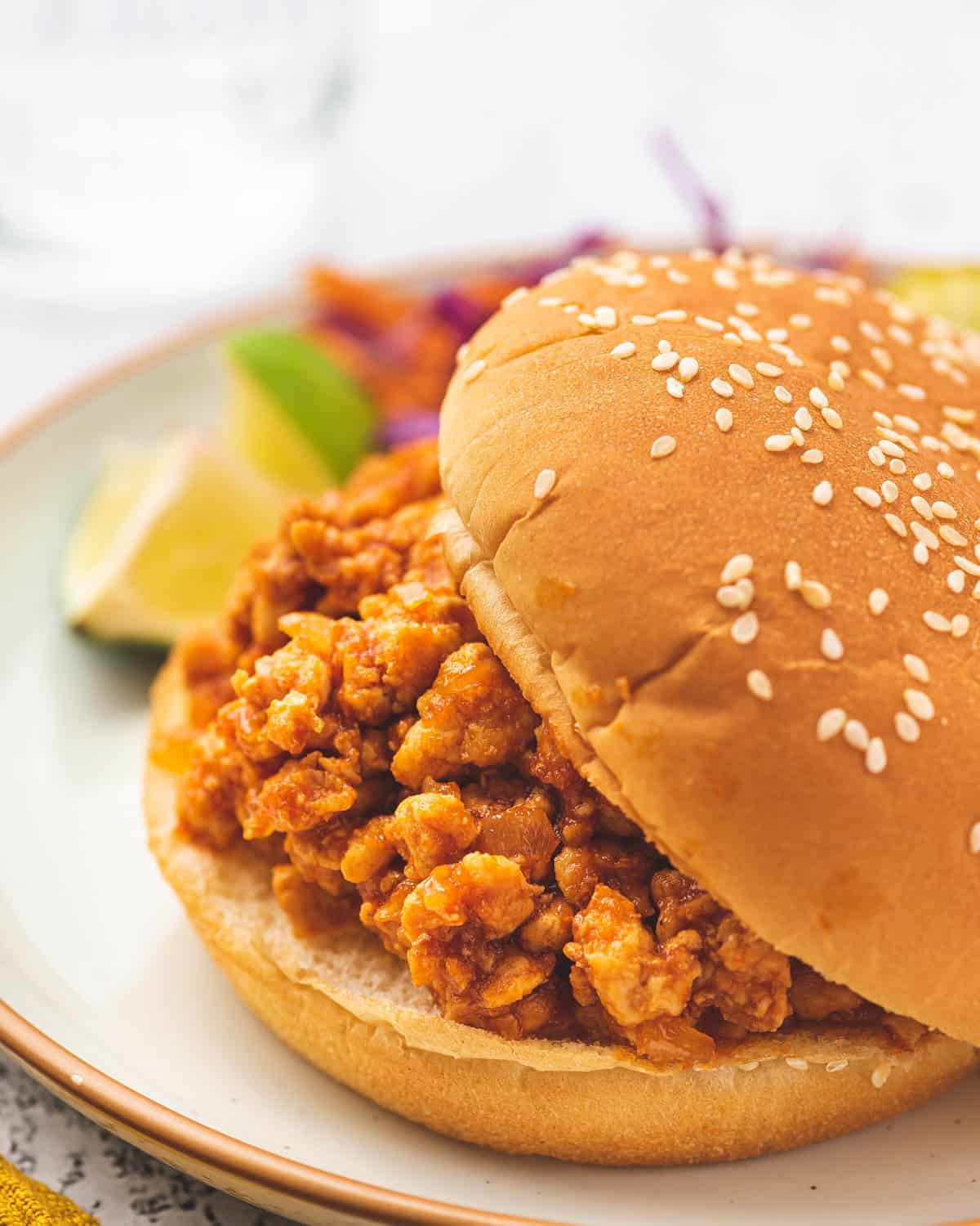 Close up of chicken sloppy joes in a burger bun.