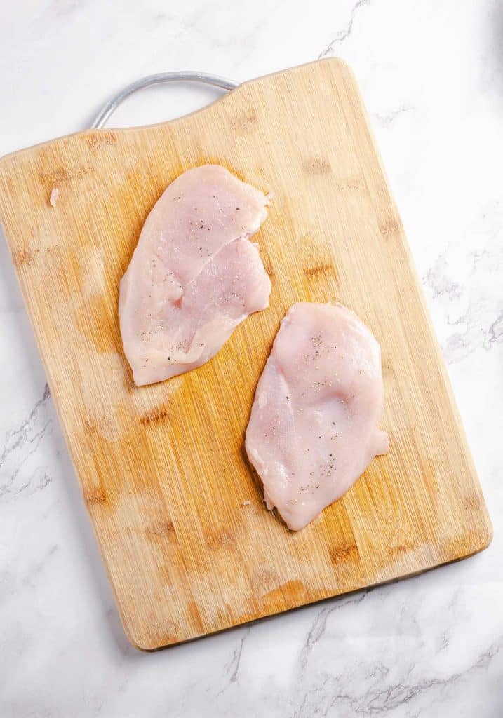 Chicken breasts seasoned and flatted.