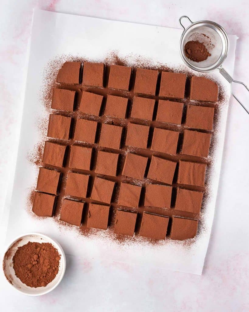 Nama chocolate cut into a grid shape and dusted with cocoa powder.