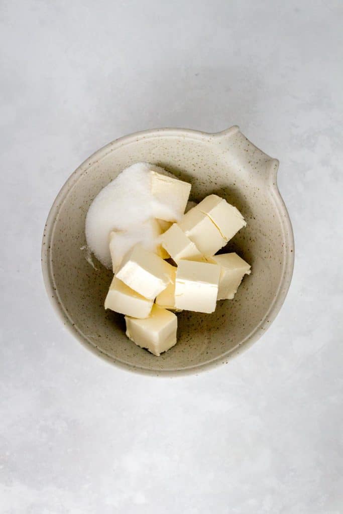 Cream cheese and sugar in a bowl.