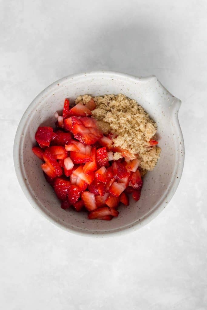 Strawberry, brown sugar, and lemon juice in a bowl.