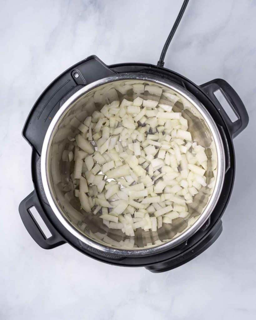 Diced onions added to an instant pot.