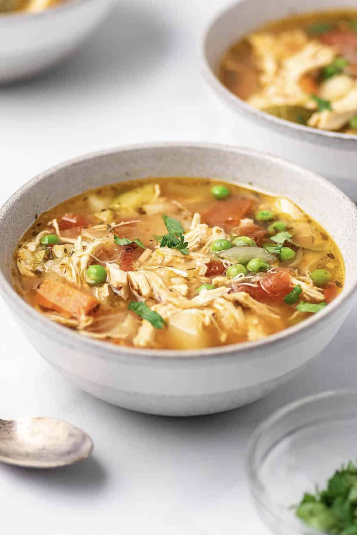 A bowl of instant pot chicken vegetable soup.