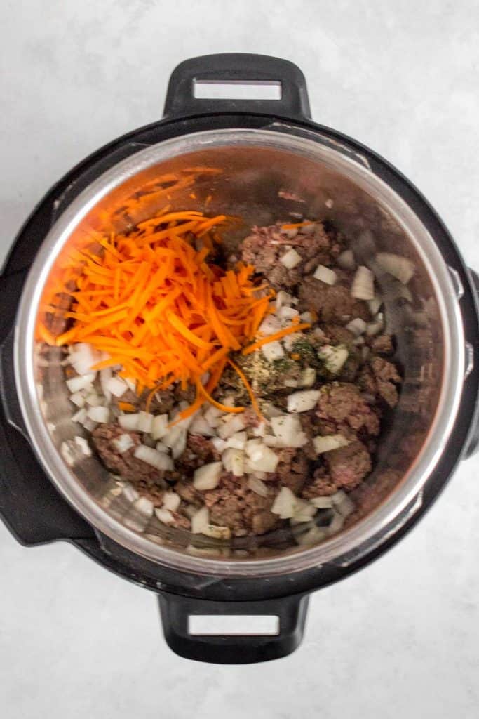 Shredded carrots added to the pot.