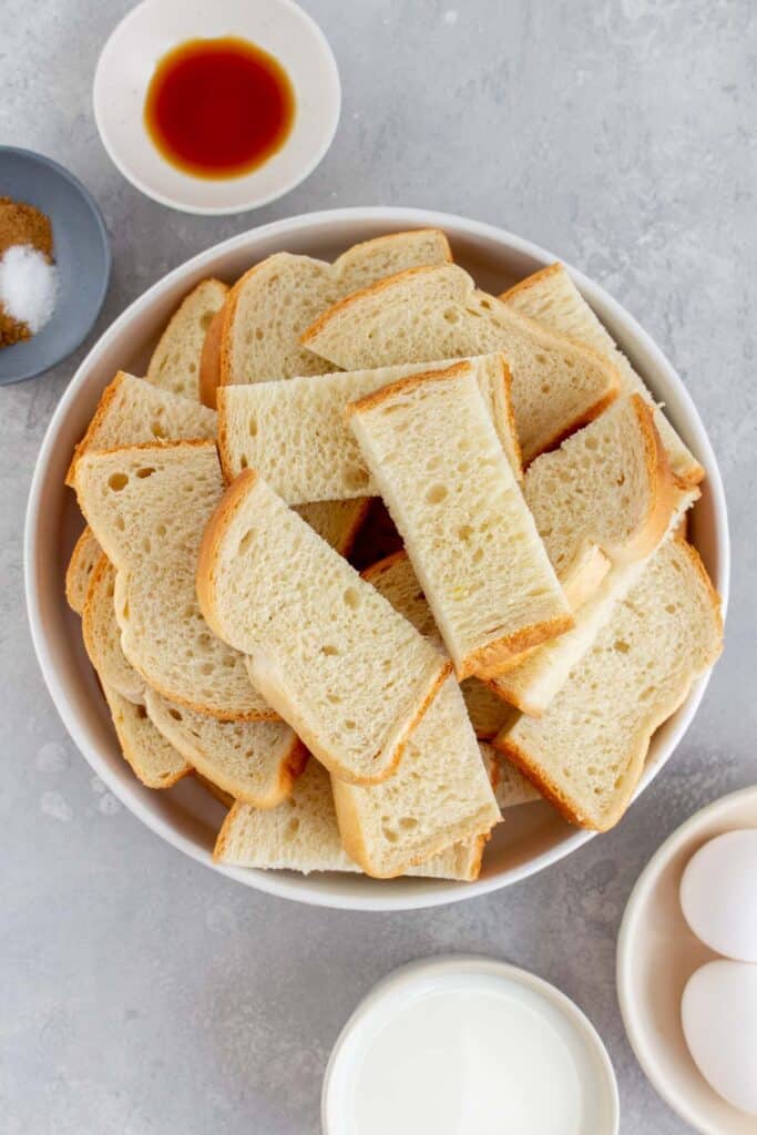 Bread slices cut into 3, all in a bowl.