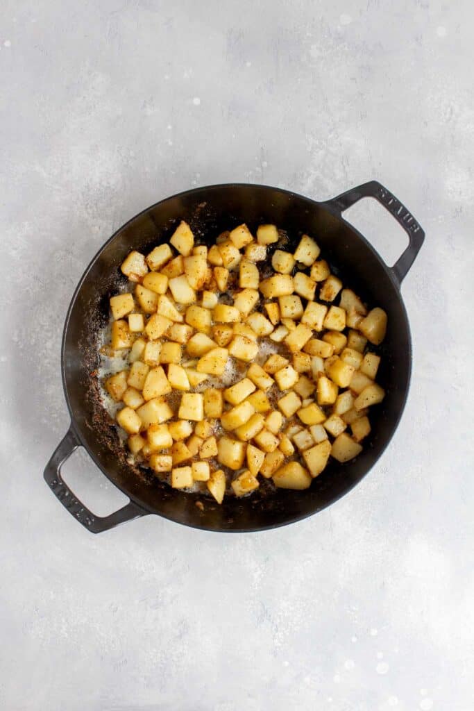 Cooked diced potatoes in a skillet.