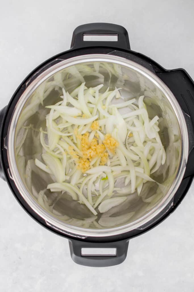 Instant Pot with onions and minced garlic.