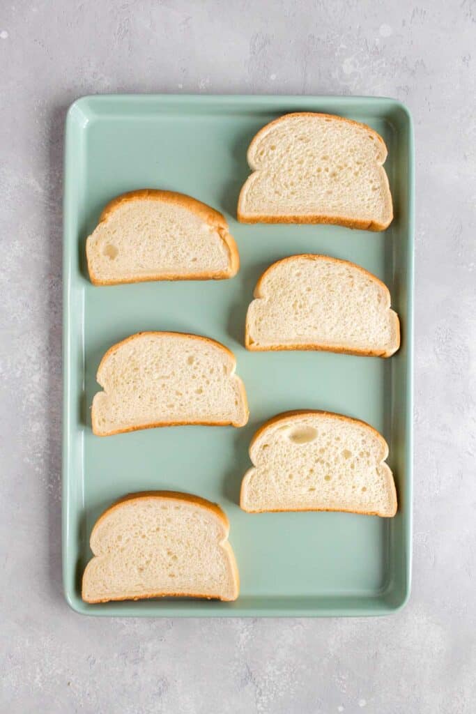 Overhead view of a sheet pan with sliced bread.