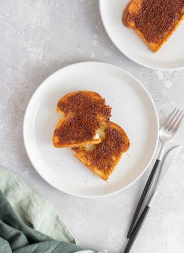 A plate with a torn piece of air fryer cinnamon toast.