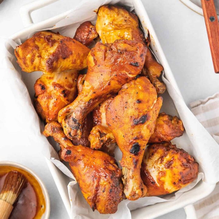 Overhead view of a rectangular dish full of slow cooker chicken drumsticks.