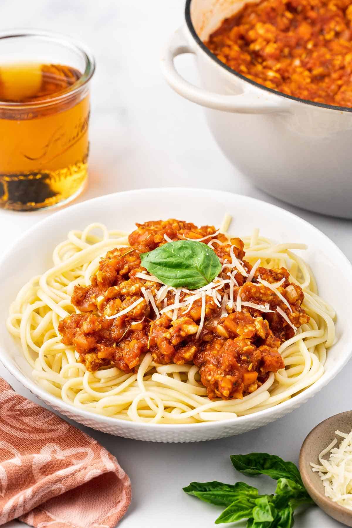 A plate of chicken bolognese with noodles.