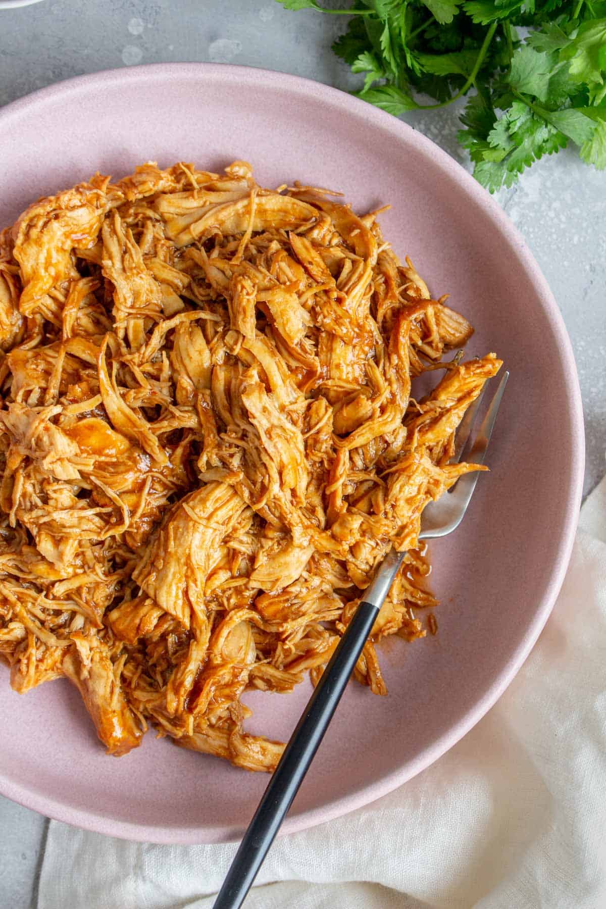 Close up overhead view of a plate of instant pot pulled chicken.