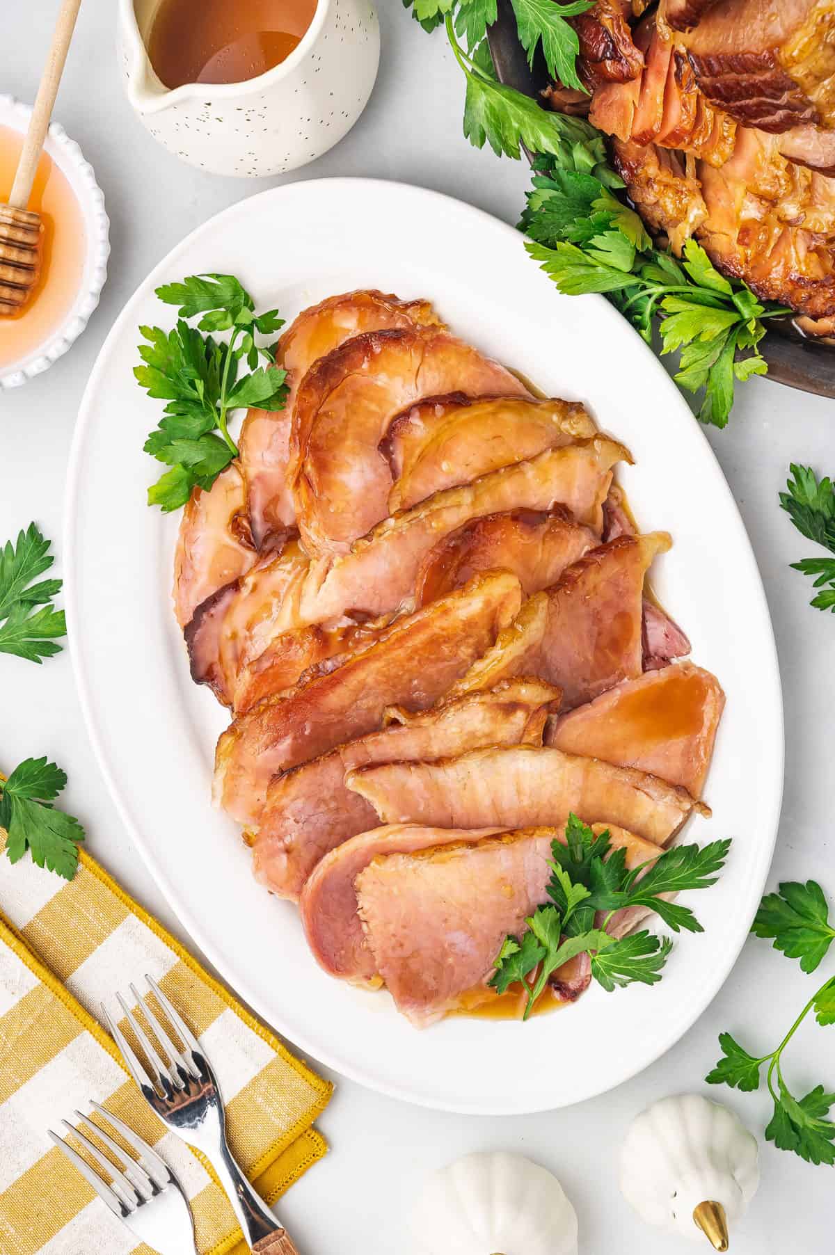 Overhead view of sliced slow cooker ham on a platter.