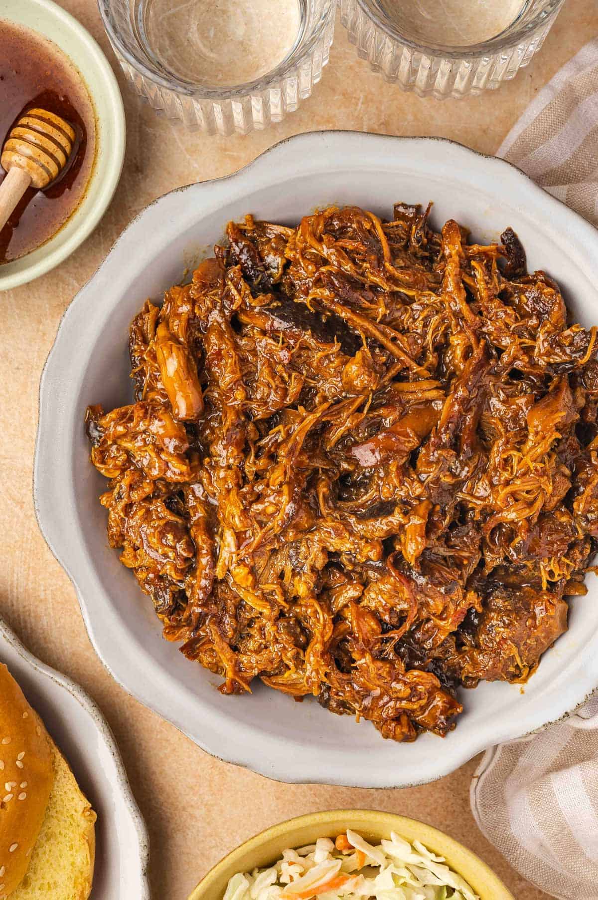 Overhead view of a platter of shredded slow cooker hot honey chicken.