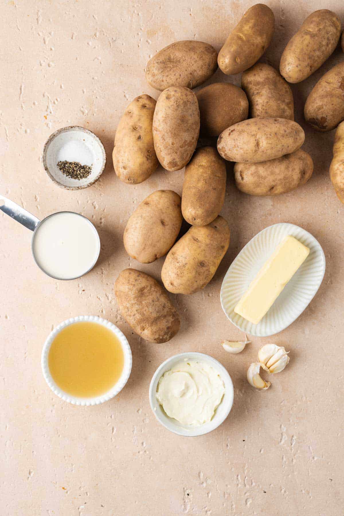 Overheard view of ingredients needed to make slow cooker mashed potatoes with sour cream and garlic.